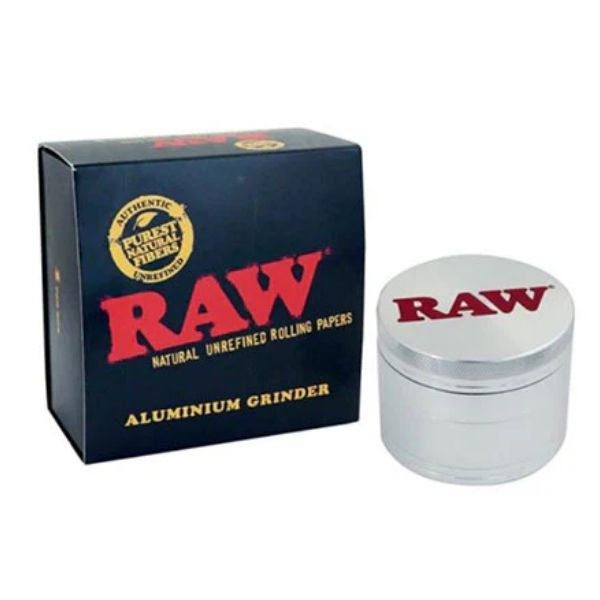 RAW brand aluminium rolling grinder next to its dark blue packaging box, featuring the iconic red RAW logo.