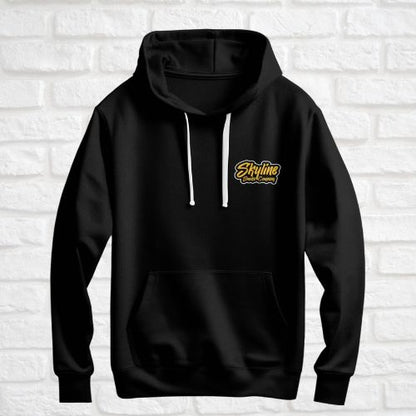 Black hoodie with a yellow logo on a white brick wall background